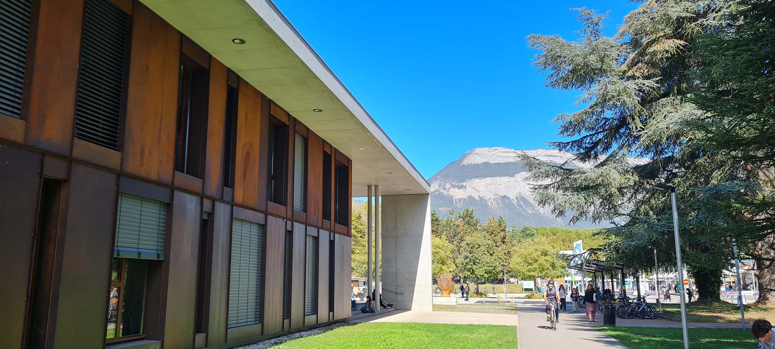 View of Grenoble Alpes University with a mountain in the background