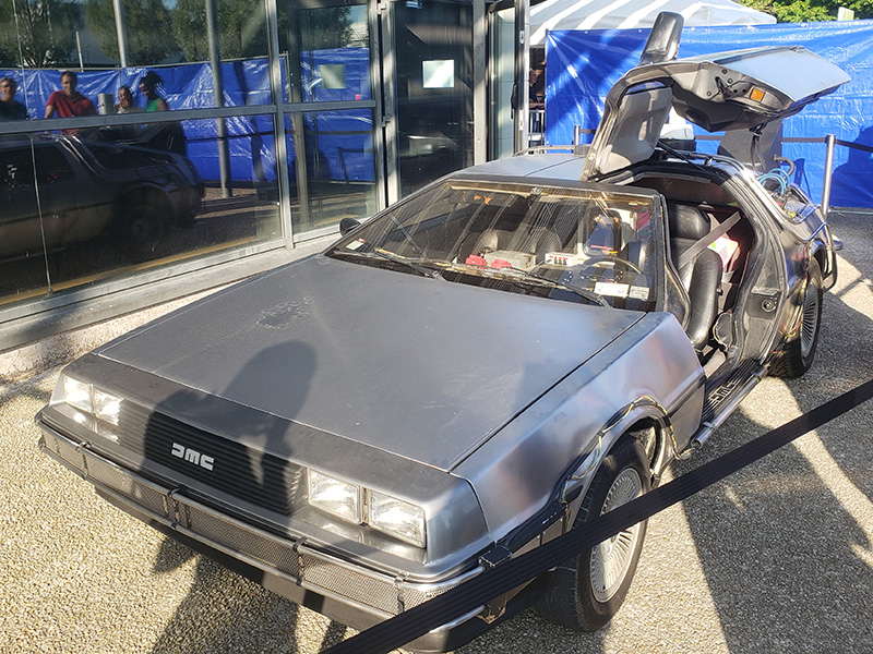 Grey Delorean car with one door open